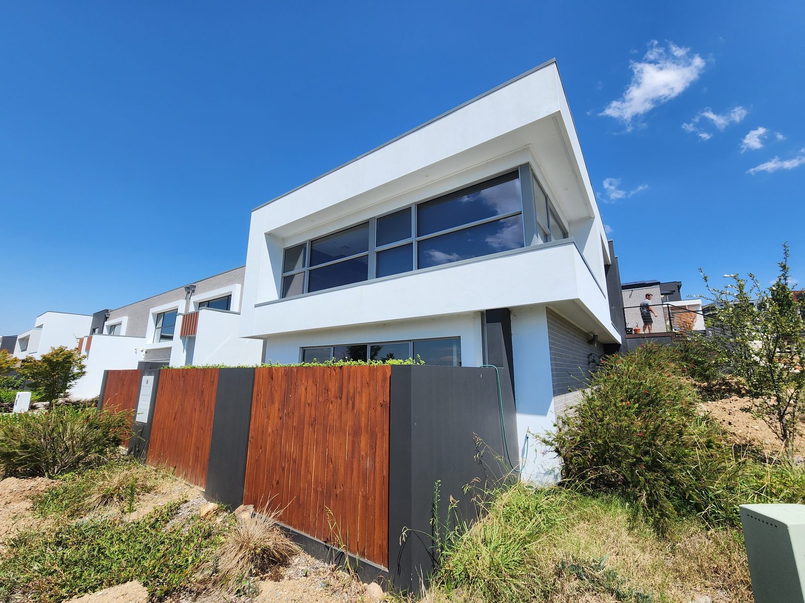 Modern two-storey home with white render and charcoal brick