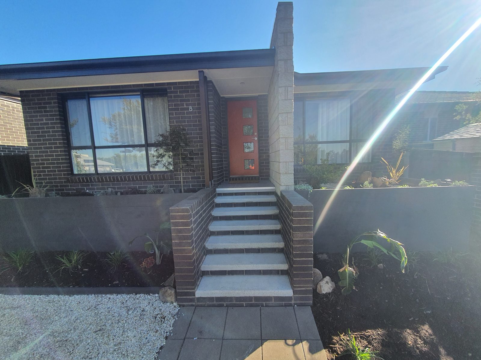 Front garden landscaping with steel planters and feature door
