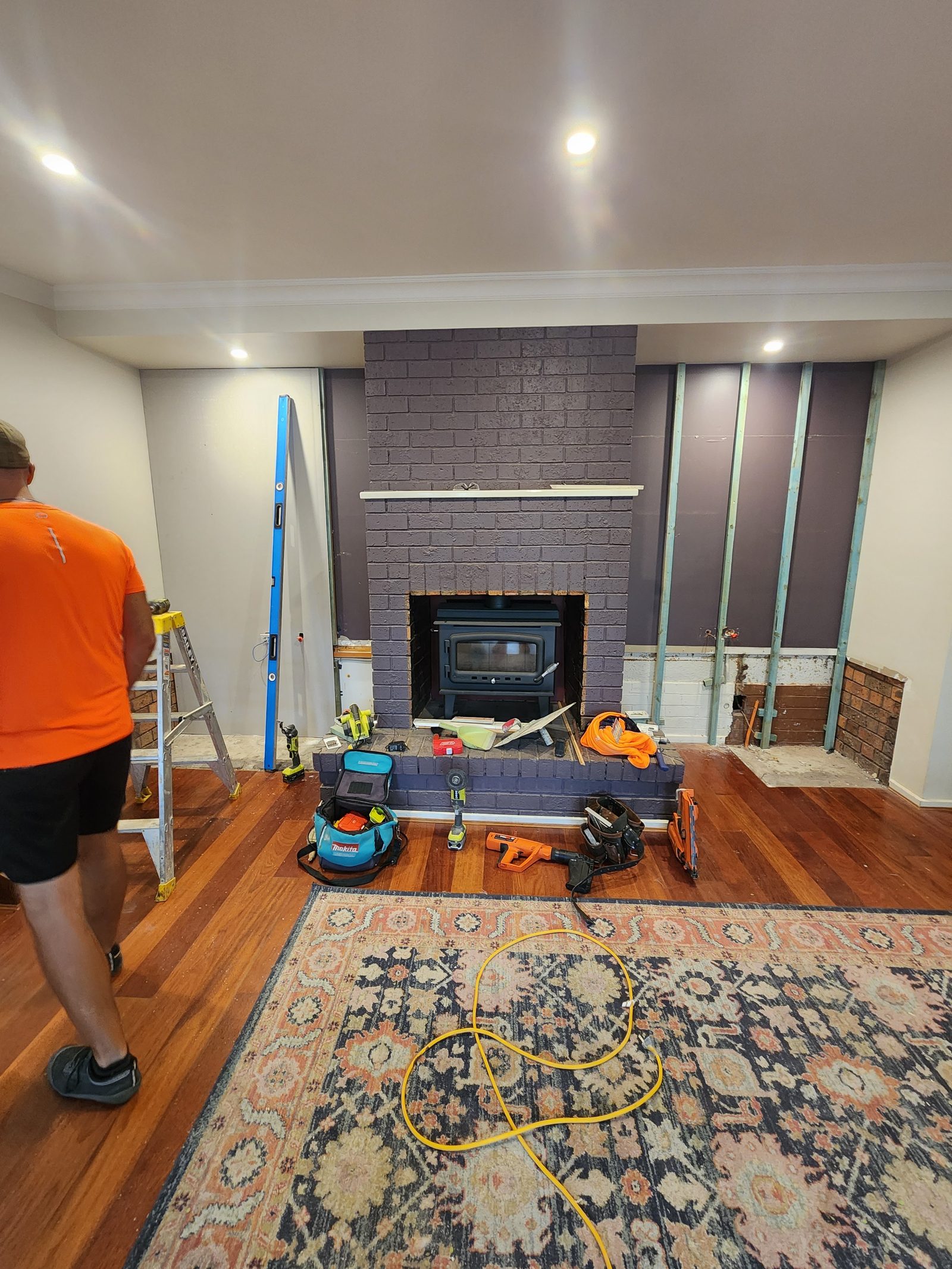 Feature fireplace renovation with charcoal brick and slow combustion insert